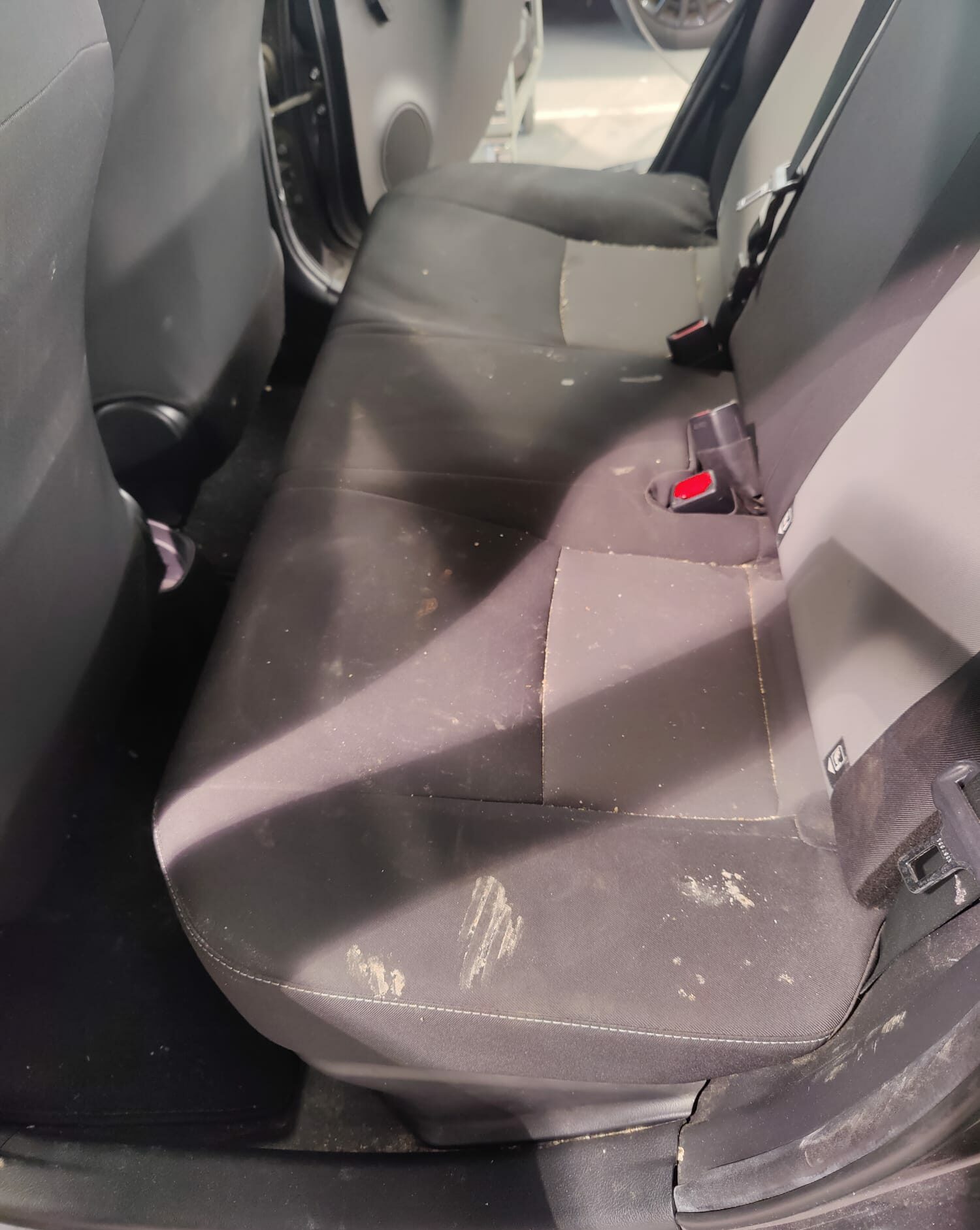 Clean'Ride - Rénovation esthétique & nettoyage automobile Banquette arrière de voiture avec taches sur tissu avant shampouinage par extraction - Clean'Ride Hérault